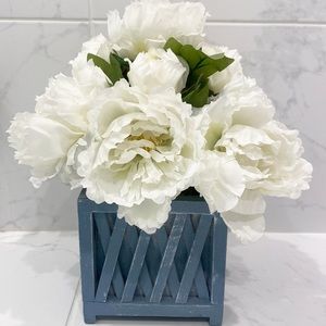Peony arrangement in wooden base.